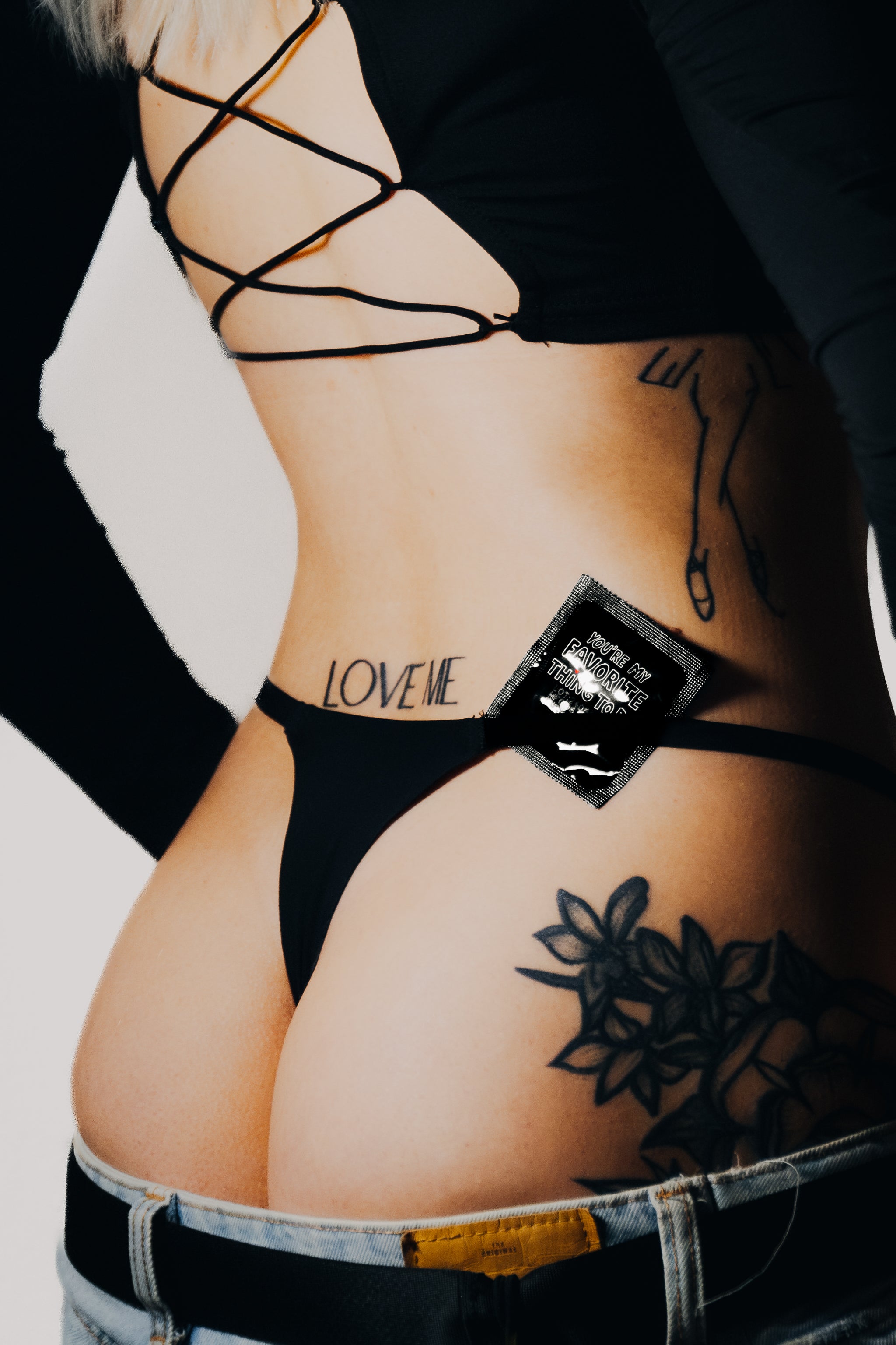 Condom behind coklitka thong, aesthetic ass photo